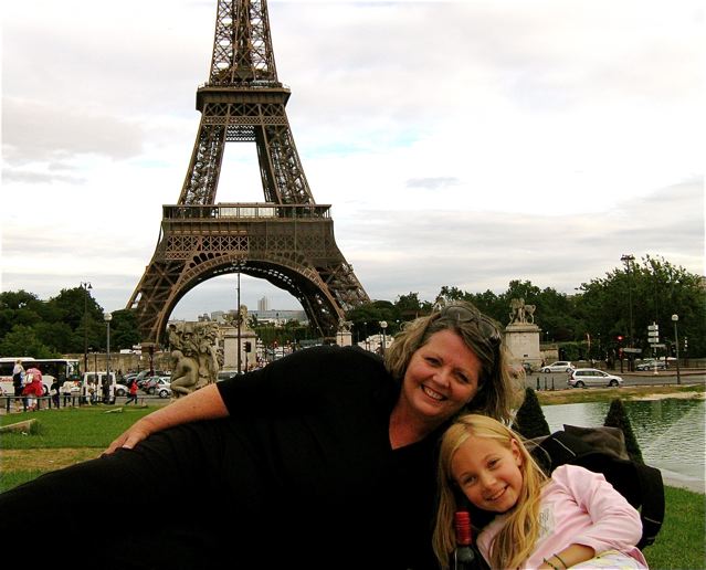 Family travel Paris, mom and daughter at Eiffel towe pinic having fun Family travel Paris, mom and daughter at Eiffel towe pinic having fun