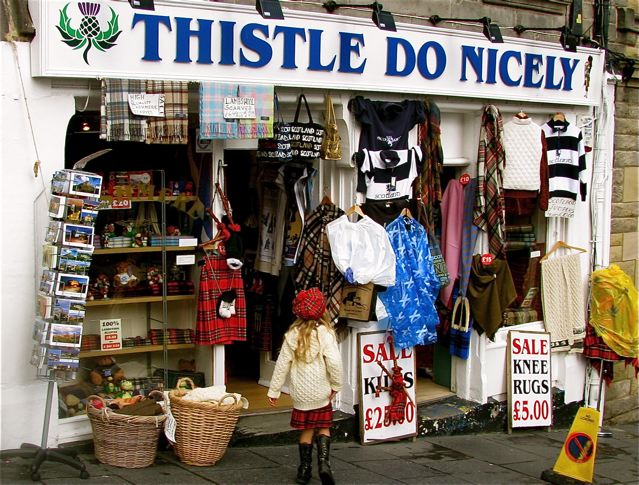 Family travel in Edinburgh, Scotland, funny signs, Edinburgh festival in kilt and tam at souvenir shop Family travel in Edinburgh, Scotland, funny signs, Edinburgh festival in kilt and tam at souvenir shop
