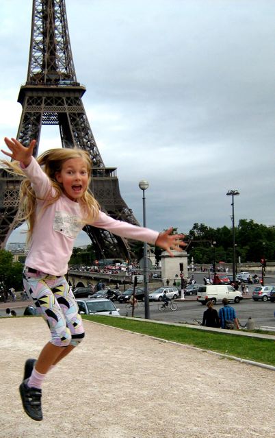 family travel Paris means a girl jumping for joy at eiffel tower family travel Paris means a girl jumping for joy at eiffel tower