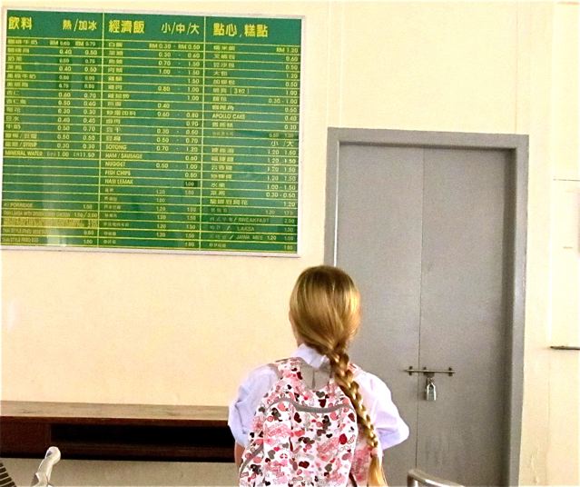 checking out extensive Mandarin food menu in the cafeteria at her Chinese school checking out extensive Mandarin food menu in the cafeteria at her Chinese school