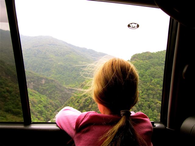 enjoying the spectacular views of Bhutan by car on high mountain cliff roads enjoying the spectacular views of Bhutan by car on high mountain cliff roads