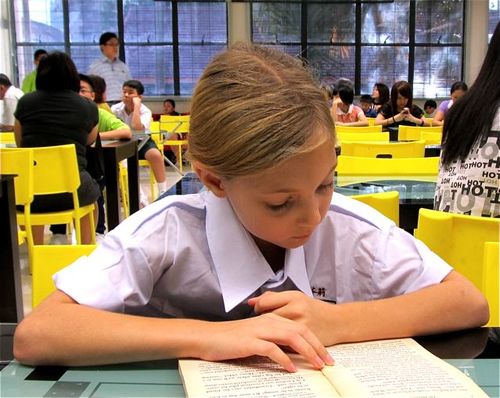 reading at the school library in Asia