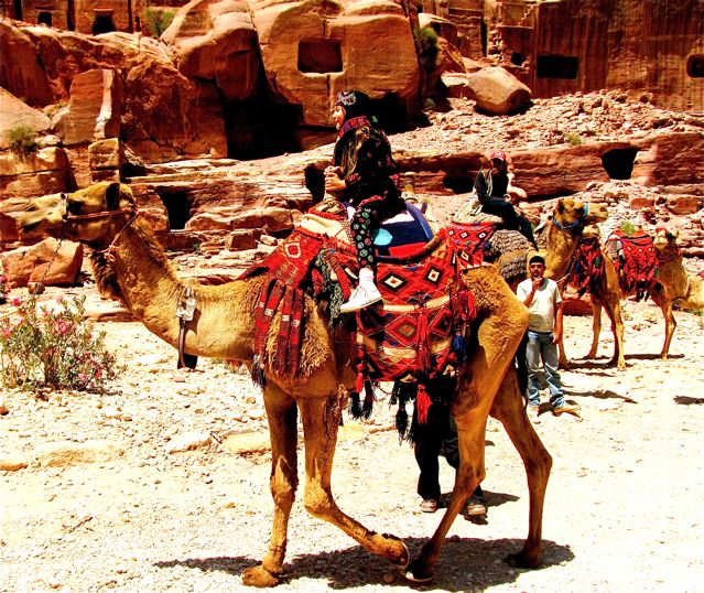 happy kid riding camel in Petra happy kid riding camel in Petra