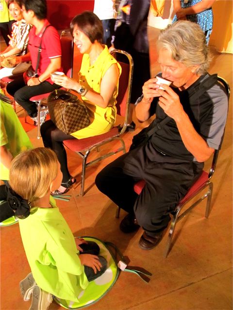 drinking the tea in the tea ceremony, child serves parent drinking the tea in the tea ceremony, child serves parent