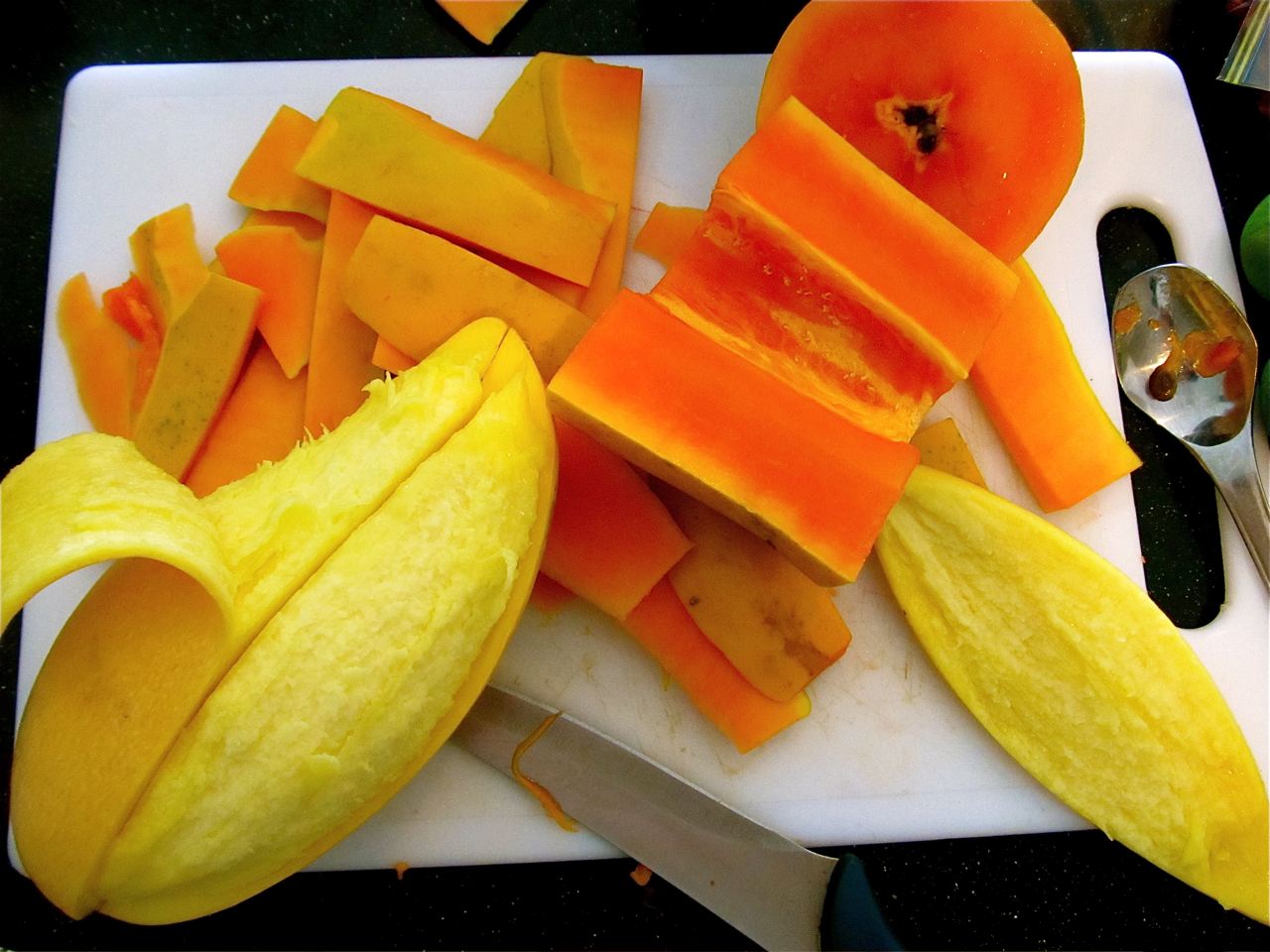 Making yummy mango and papaya chutney- cutting up the fruit Making yummy mango and papaya chutney- cutting up the fruit
