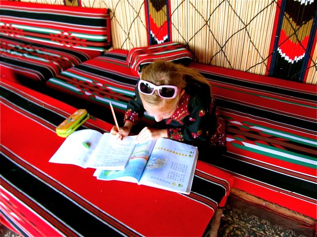 Homeschooling around the world- our American kid doing Mandarin homework in Wadi Rum Jordan Homeschooling around the world- our American kid doing Mandarin homework in Wadi Rum Jordan
