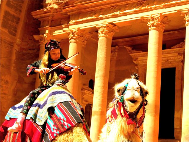 playing violin on a camel in Petra, Jordan playing violin on a camel in Petra, Jordan