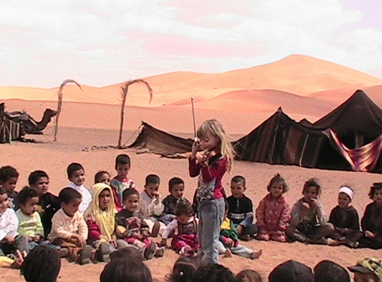 A 6 year old child doing volunteer work in Morocco's Sahara A 6 year old child doing volunteer work in Morocco's Sahara