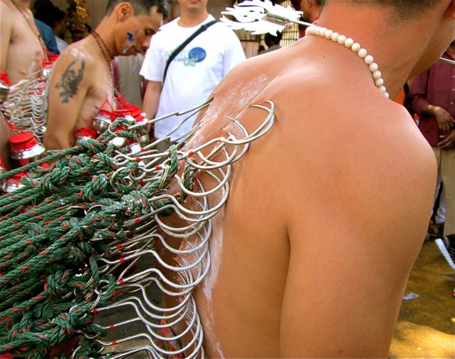 Thaipusam festival hooks pierced into back pulling large alter in trance Thaipusam festival hooks pierced into back pulling large alter in trance