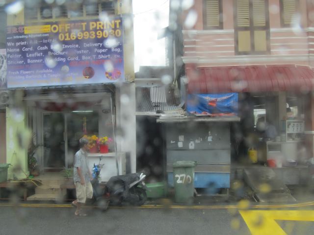 view from bus window in rainy downpour in Penang /no side walks view from bus window in rainy downpour in Penang /no side walks