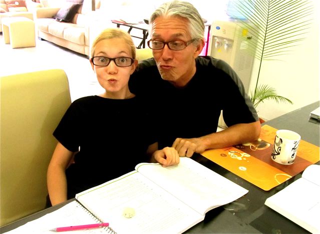 Dad and Daughter math geeks having fun with advanced Geometry and Algebra homeschool at the dining room table ( fake glasses for her) Dad and Daughter math geeks having fun with advanced Geometry and Algebra homeschool at the dining room table ( fake glasses for her)
