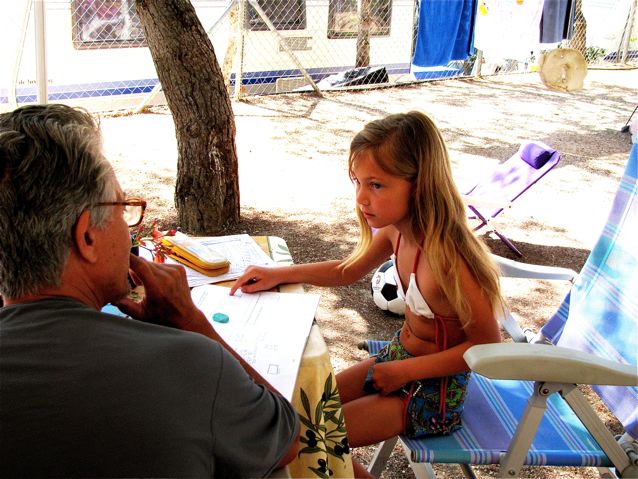 Father helping Daughter with math outside while camping in Barcelona Father helping Daughter with math outside while camping in Barcelona