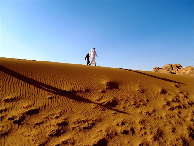 World's Most Well-Traveled Child exploring Wadi Rum on foot with Bedouin friend and guide World's Most Well-Traveled Child exploring Wadi Rum on foot with Bedouin friend and guide