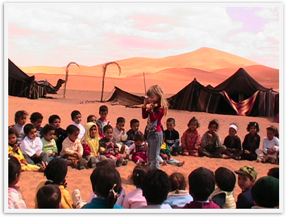 Mozart at 6 playing violin for kids as a service project in Morocco's Sahara desert