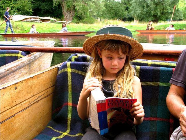 Travel kid Mozart reading Harry Potter book in Cambridge, UK. 
