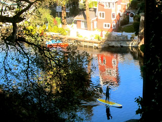 beauty every where like girl on surfboard in Capitola on the river headed to the sea