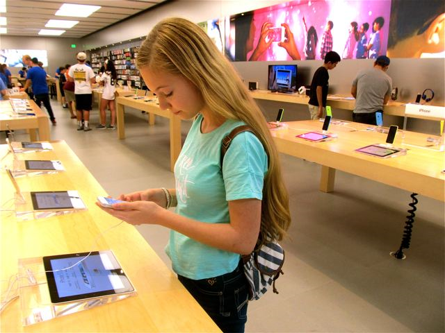 RTW travel teen Mozart shopping at the Apple store for an iphone and ipad RTW travel teen Mozart shopping at the Apple store for an iphone and ipad