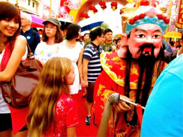 Blond American travel kid Mozart in Asia crowd celebrating Chinese New Year Blond American travel kid Mozart in Asia crowd celebrating Chinese New Year
