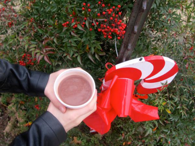 Hot chocolate and candy cane outside at Christmas time Hot chocolate and candy cane outside at Christmas time